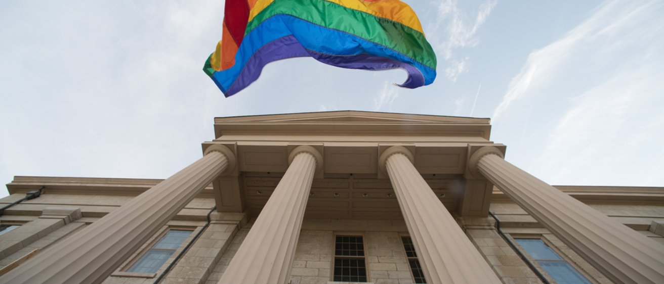 Pride flag flying above the Old Capitol 