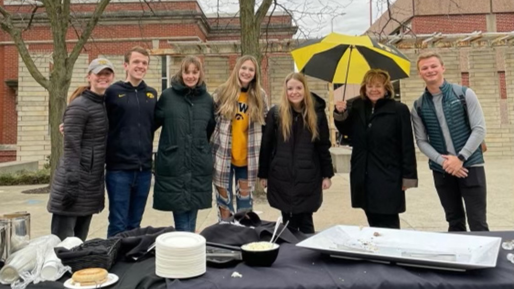 group of students outdoors with president Barbara Wilson