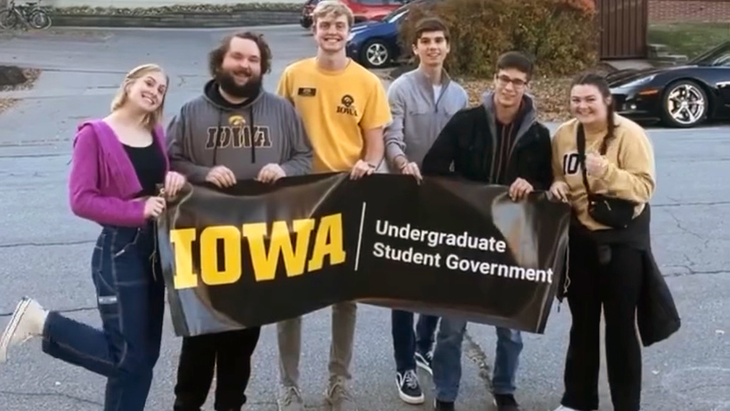 group of students holding banner